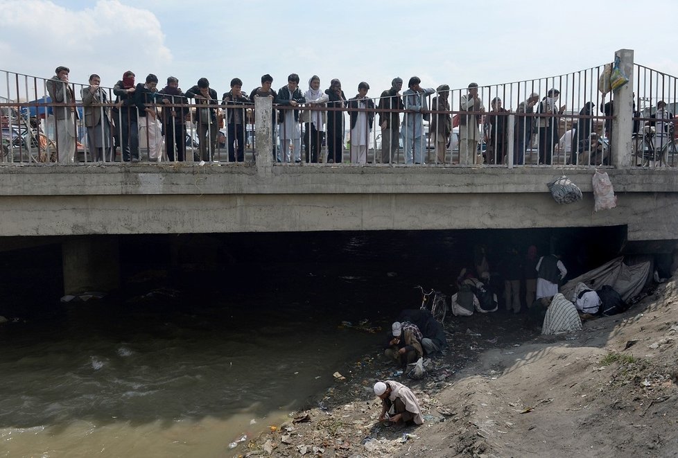 Afghánští narkomané pod mostem, mezi odpadky a ve spíchnutých přístřešcích.