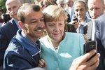 Angela Merkelová a společné fotografie s uprchlíky