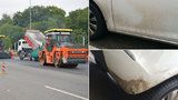 Auta poničená od asfaltu: Silničáři z Bucharovy ulice udělali špinavou past, umytí řidičům zaplatí