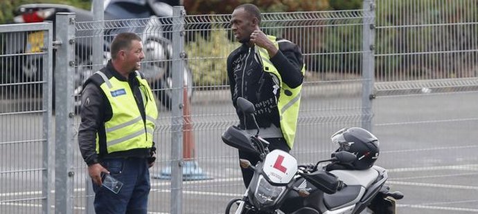 Bolt si obléká vestu, aby mohl usednout na motocykl. Instruktor byl vykulený, koho na jízdách má.