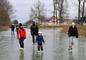 Zamrzlá hladina Baťova kanálu láká bruslaře.