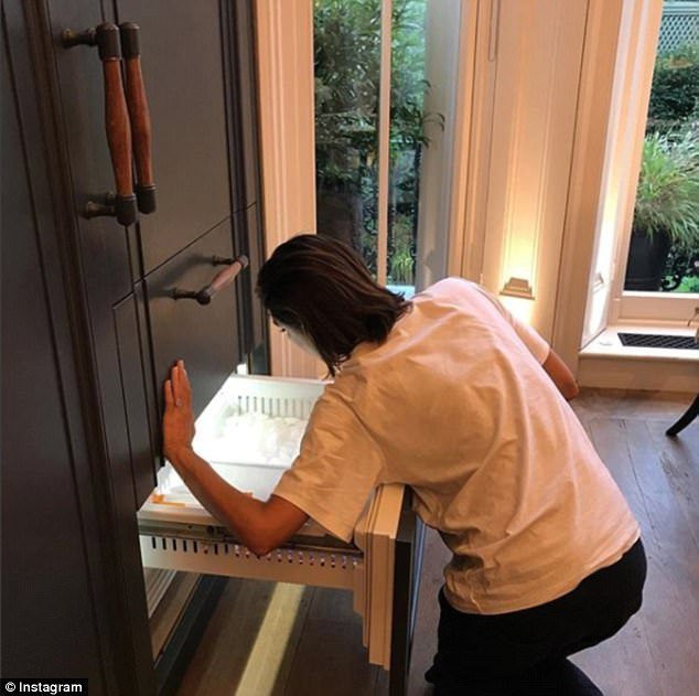 Victoria Beckham hledá něco v mrazáku.