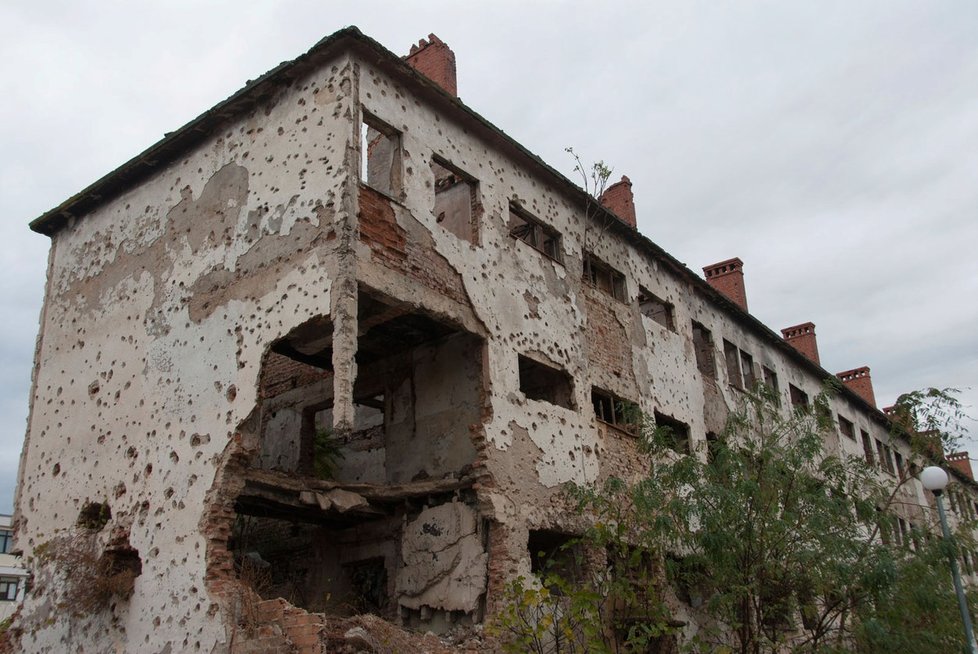 Zničená budova s dírami po kulkách, Bosna a Hercegovina