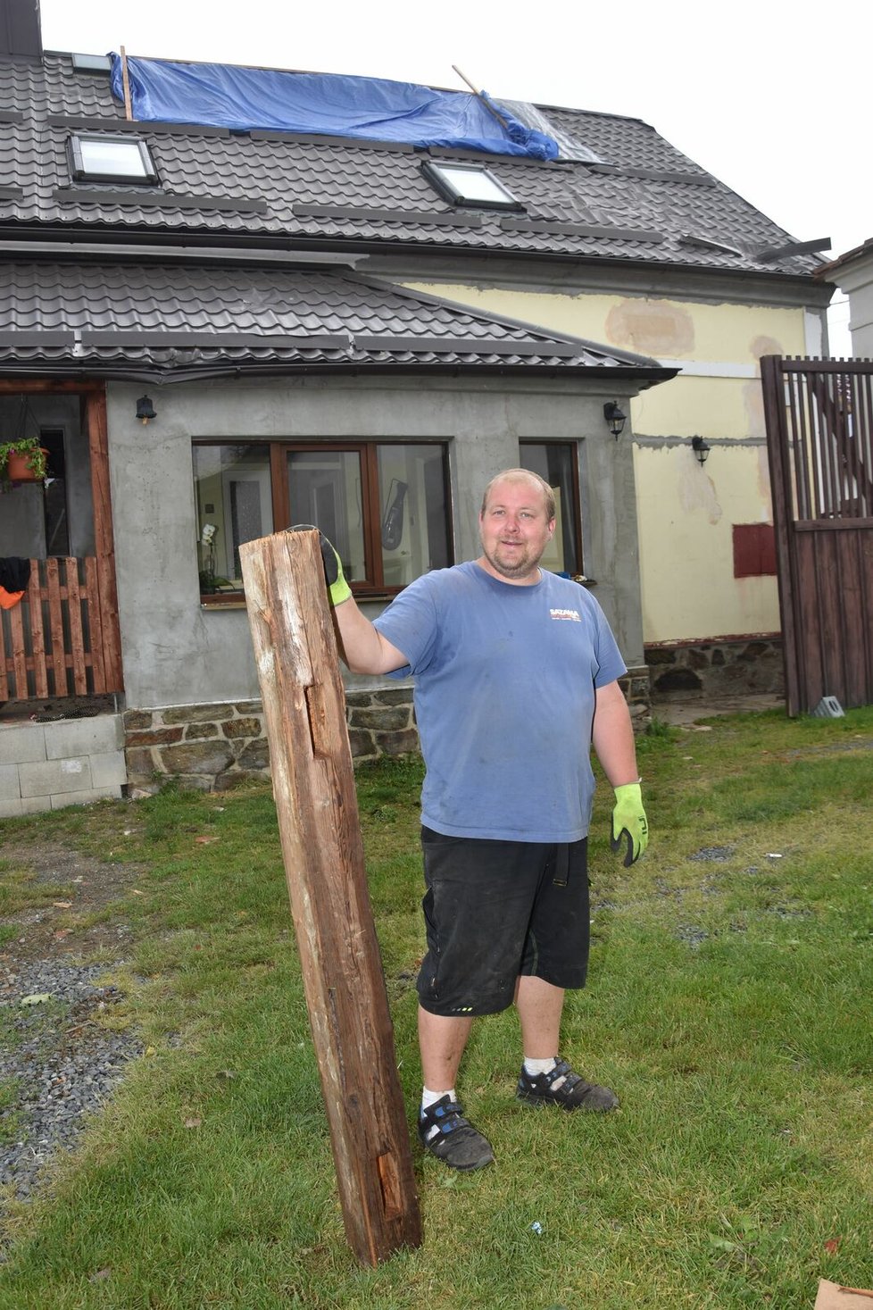 Václav Šimánek ukazuje část, teď už rozřezaného trámu, který se zabodl do okna verandy.