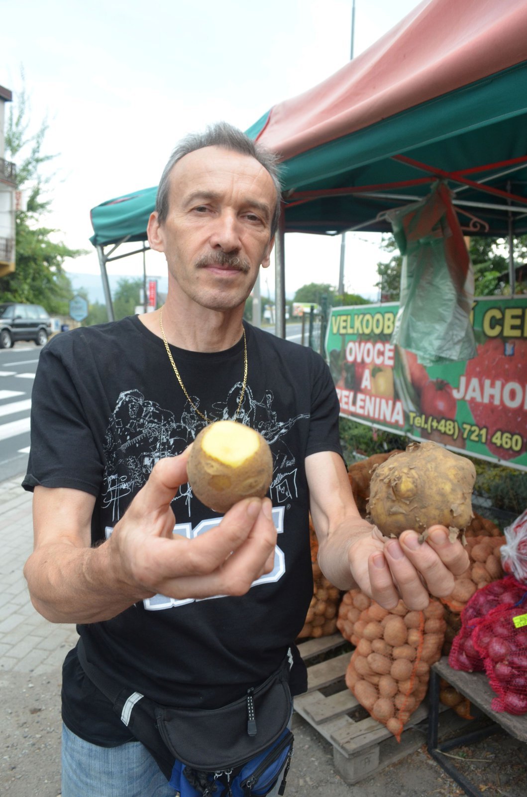 ﷯Polský prodejce ukázal rozříznutý brambor, aby přesvědčil o jeho kvalitě