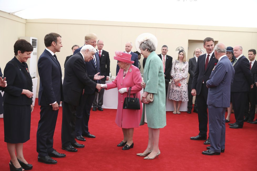 Královna Alžběta II. a premiérka Mayová vítají hosty na oslavách 75. výročí Dne D, (5.06.2019).