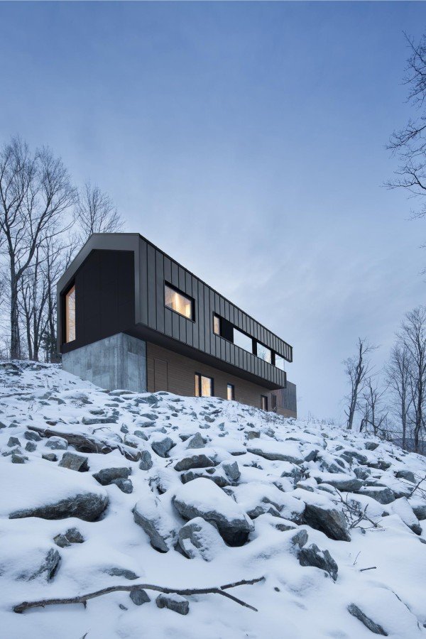 Minimalistický dům na kanadském venkově pluje mezi korunami stromů
