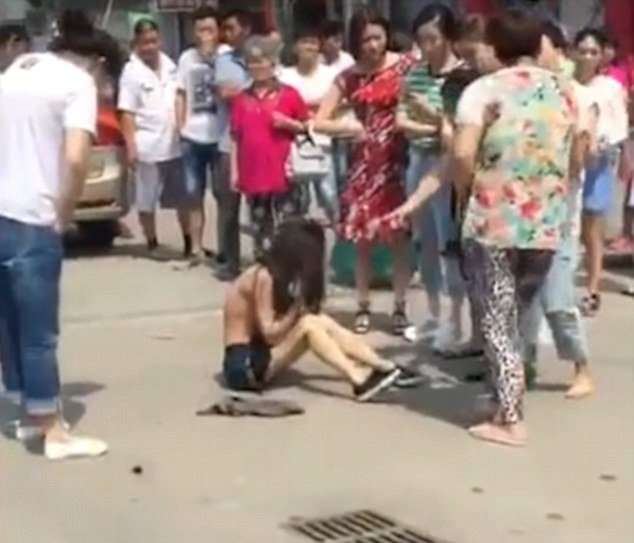 Ponížení milenky v Číně: Manželka z milenky strhala oblečení.