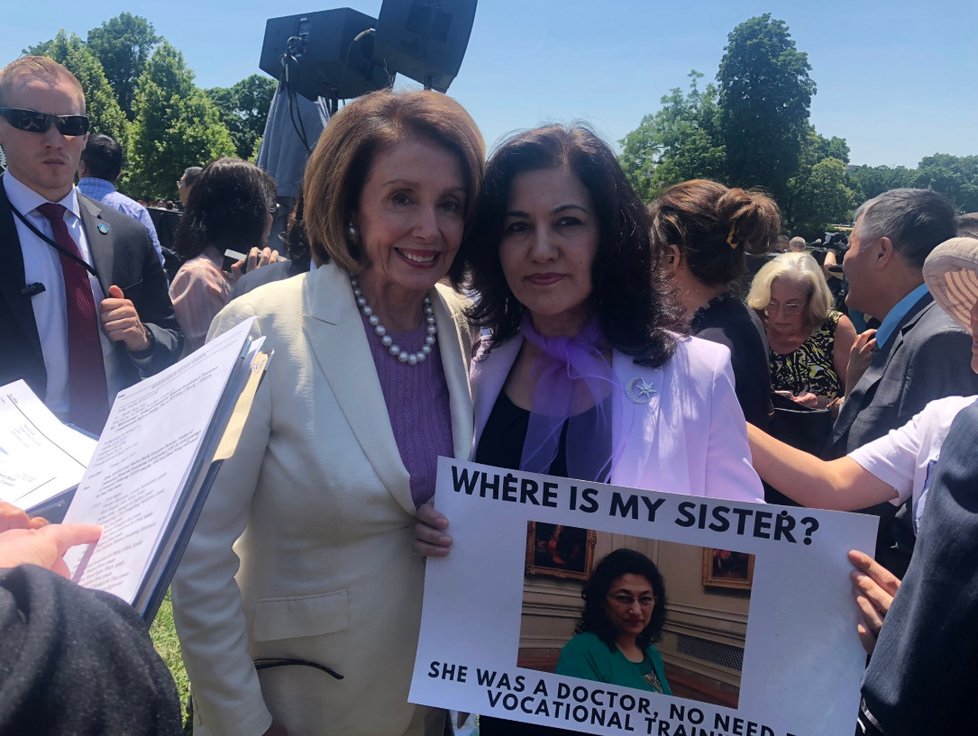 Rušan Abbasová, představitelka ujgurského exilu, bojuje proti utlačování Ujrugů v Číně. Na snímku s šéfkou amerických demokratů Nancy Pelosiovou, na transparentu má fotku své sestry, která je držena v jednom z převýchovných táborů.