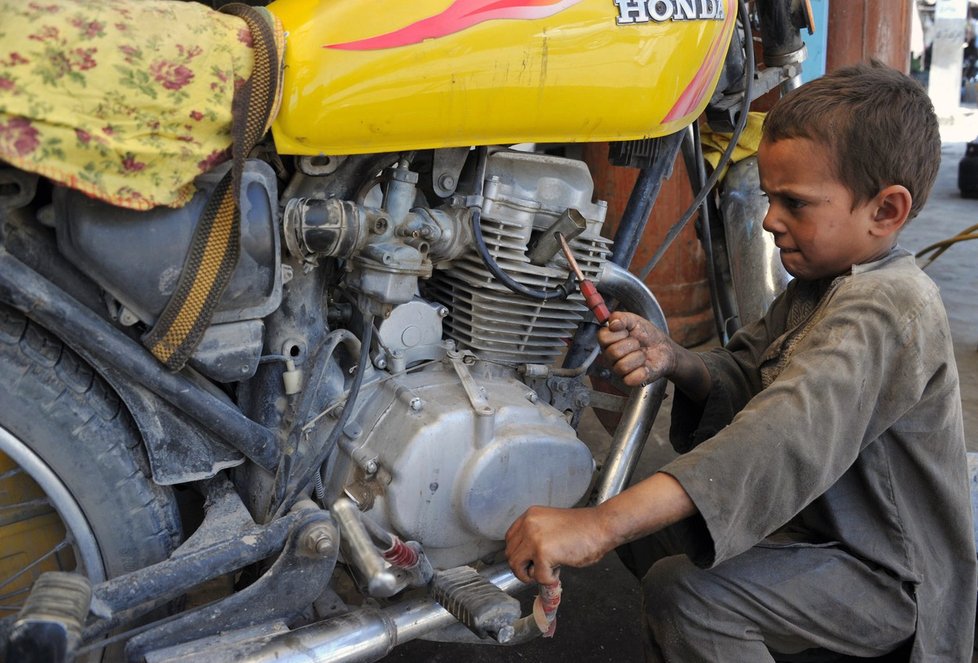 Chlapec pracuje v prodejně a opravně motocyklů ve městě Džalálábád ve východním Afghánistánu.