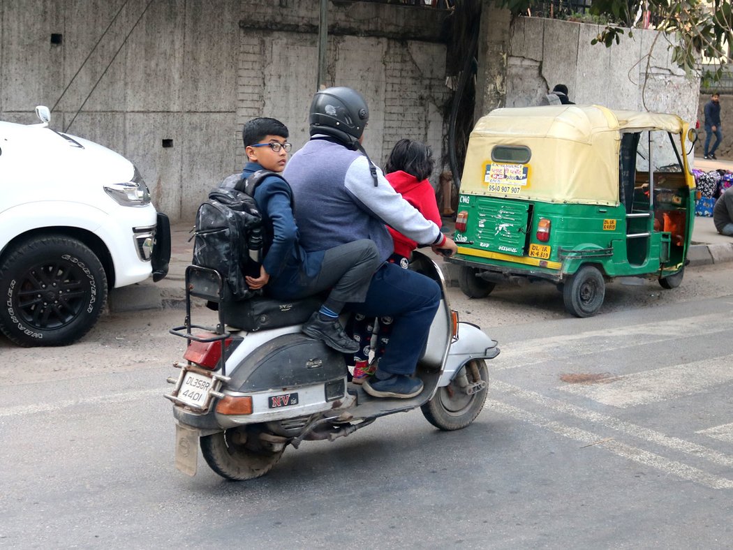 Jezdit v Indii bez helmy považujeme za sebevraždu, vozit tak děti za vraždu. Stát proti tomu bojuje – indické motorky mají registrační značku i vpředu, takže policisté chodí po přechodech, fotí si provinilce a rozesílají pokuty.