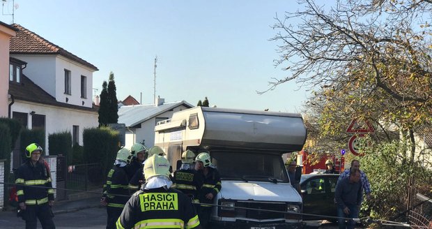 Auto popelářů na Bílé Hoře skončilo na boku v zahradě.