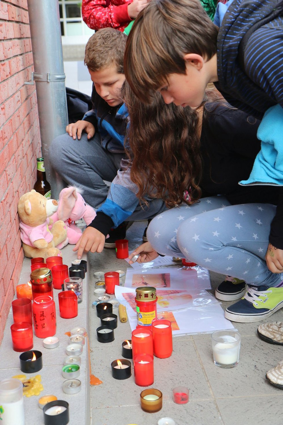 Po skončení vyučování se děti ze základní školy v Dubňanech zastavují u hlavní budovy školy a zapalují u ní svíčky.