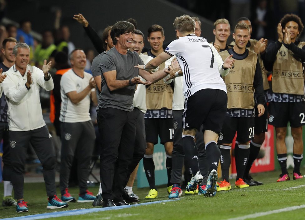 Německý trenér Joachim Löw gratuluje Bastianu Schweinsteigerovi po gólu proti Ukrajině