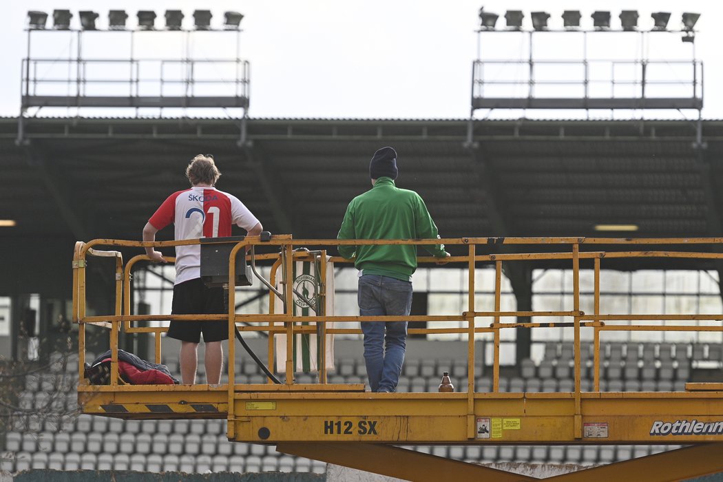 Fanoušci, kteří se kvůli koronavirové pandemii nedostali na stadion, čekají na mobilní plošině na začátek zápasu Bohemians - Slavia