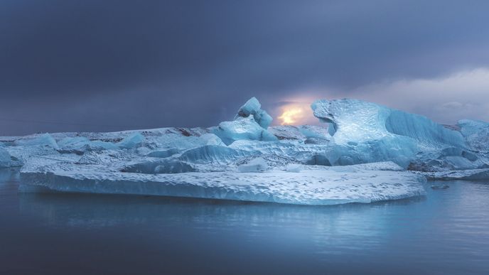 Island: slunce prosvítající bouřkovými mraky a ledovcem Jökulsárlón
