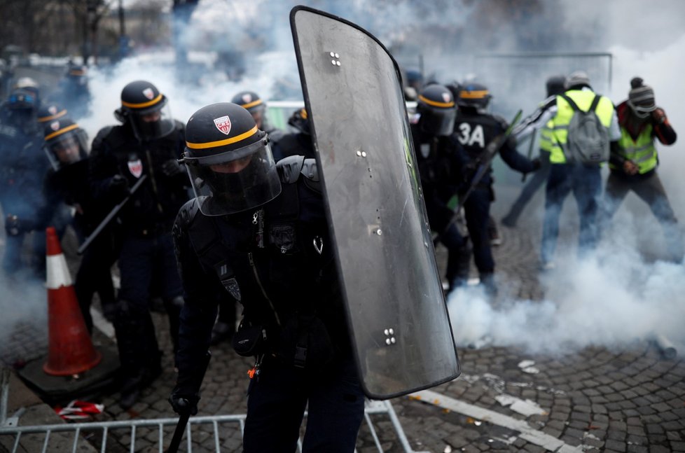 I přes zákaz demonstrací na pařížské třídě Champs-Elysées se tu několik stovek lidí domáhá Macronovy demise. Média hlásí první potyčky a slzný plyn.