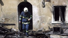 Hasič likviduje zbytky požáru