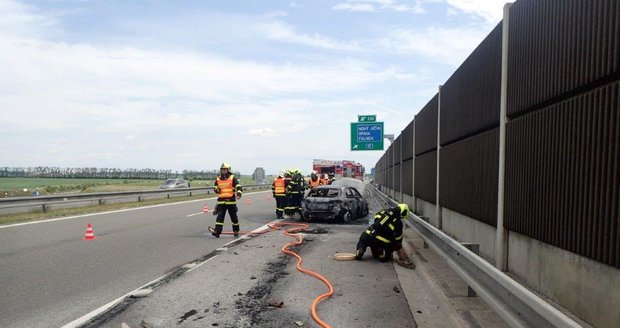 Hasiči po uhašení požáru museli dálnici uklidit.
