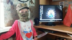 Na monitoru visí logo batalionu Azov. Malá holčička vykřikuje, že bude ráda podřezávat Rusy, a mává u toho nožem.