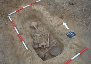 Hrob z přelomu pozdní doby kamenné a starší doby bronzové (asi 2300 př. n. l.). Leží v něm skrčená kostra s hlavou otočenou k východu. Hrob objevený u Rajhradu obsahoval i misku, dva malé a jeden větší džbánek.
