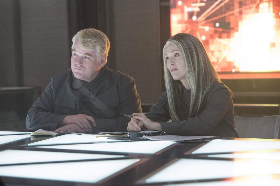 Philip Seymour Hoffman (Plutarch Heavensbee) a Julianne Moore (Alma Coin)