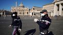 Policisté hlídkují na prázdném Svatopetrském náměstí ve Vatikánu.