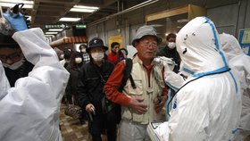 Lidé z evakuovaných oblastí prochází důkladným testem měřícím obsah radiace v jejich těle