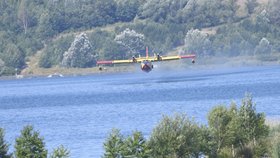 Italské hasicí letadla nabírají vodu v jezeře Milada u Ústí nad Labem. (28.7.2022)