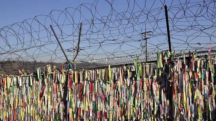 Stužky přivázané na hraničním plotě slouží jako modlitba za sjednocení dvou znepřátelených národů