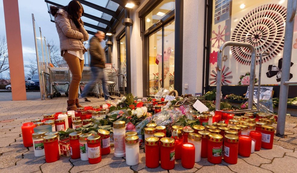Svíčky před obchodem, kde došlo k útoku.