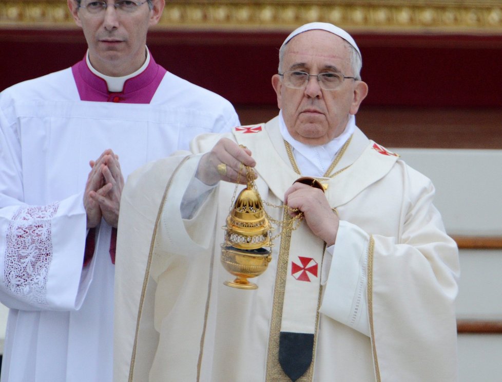 Papež František mává během svatořečení kadidlem.