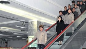 Kim Kjong-hi s Kim-Čong-ilem a Kim Čong-unem na eskalátoru
