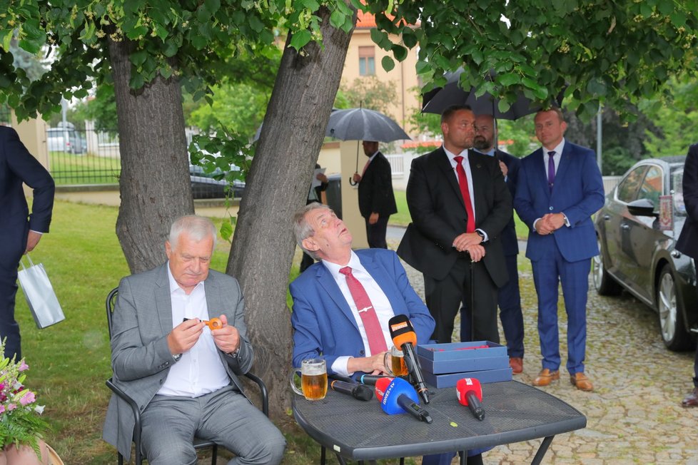 Exprezident Václav Klaus si na oslavě svých 78. narozenin prohlíží dárek od prezidenta Miloše Zemana (19. 6. 2019)