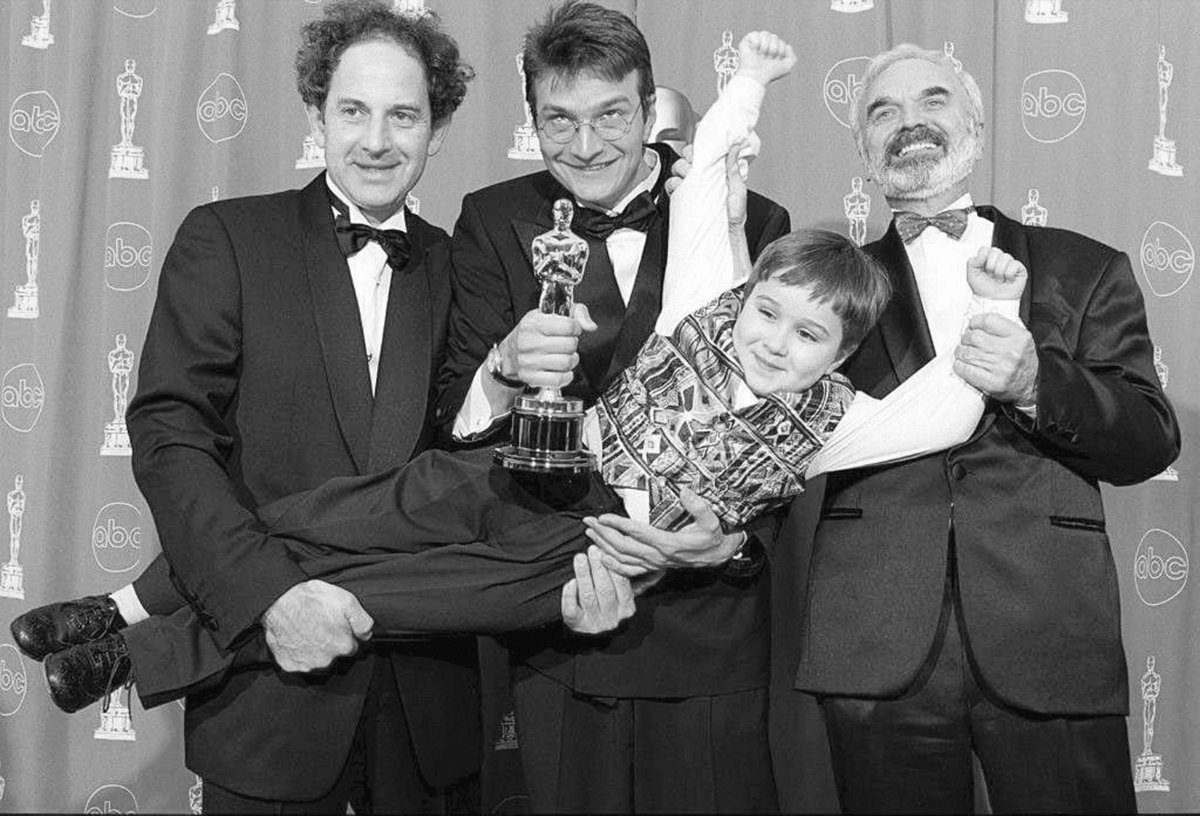 Zdenek Sverak(R), Jan Sverak(C) and Eric Abraham(L) hold Andrei Chalimon after they won the Oscar for best foreign film for &#34;Kolya&#34; during the 69th Annual Academy Awards 24 March 1997 in Los Angeles. It was the first Academy Award won for a film from the Czech Republic. AFP PHOTO Kim Kulish