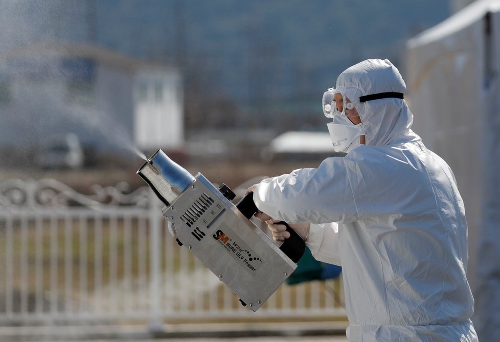 Pracovníci dezinfikují zařízení pro testování na koronavirus v jihokorejském okrese Cheongdo (11. 3. 2020)