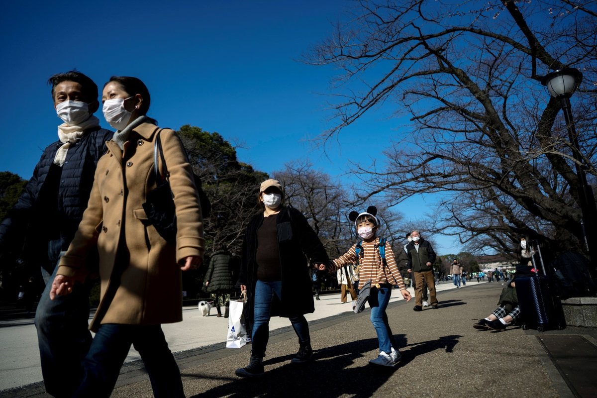 Lidé v ochranných rouškách v parku Ueno v Tokiu
