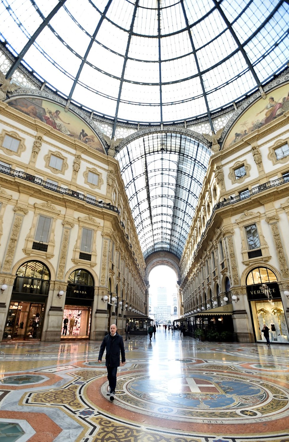 Lidé v rouškách v galerii Galleria Vittorio Emanuele II. v italském Miláně