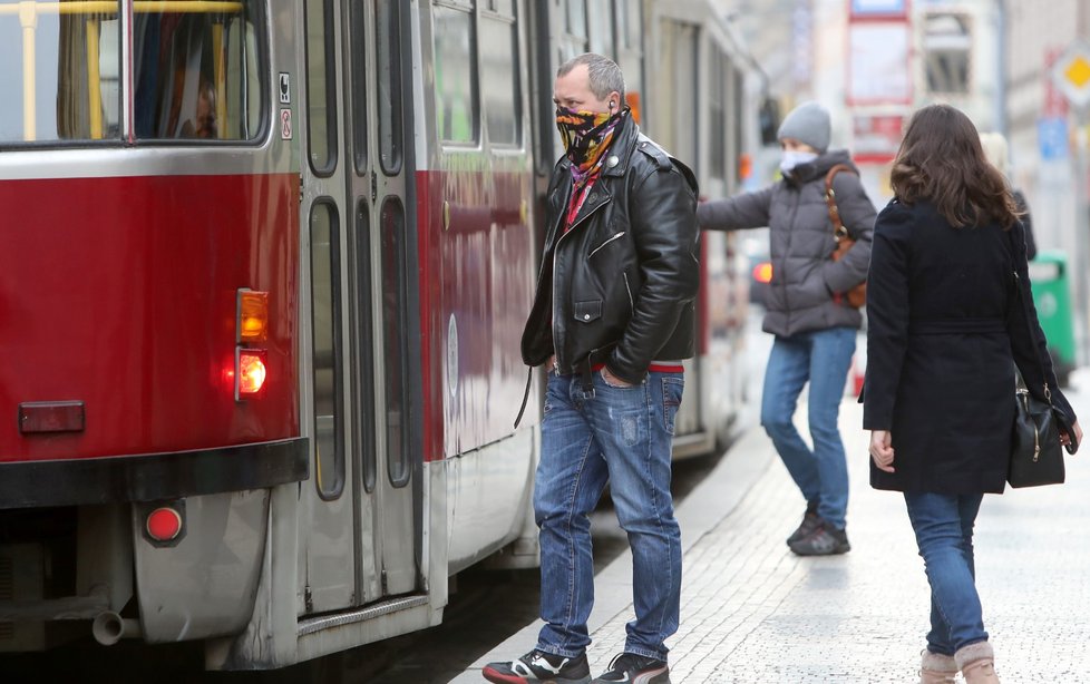 Lidé nosí roušky i v tramvajích.