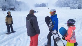 Správce Ski areálu v Olešnici František Jílek (zády) lyžařům vysvětluje, že kvůli nařízení vlády na hlavní sjezdovku nesmějí.
