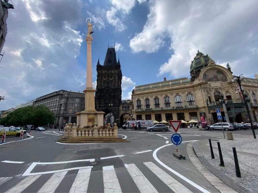 Historický sloup, kolem kterého se vine asfaltový objezd, poukazuje na ironii moderního zásahu do centra UNESCO