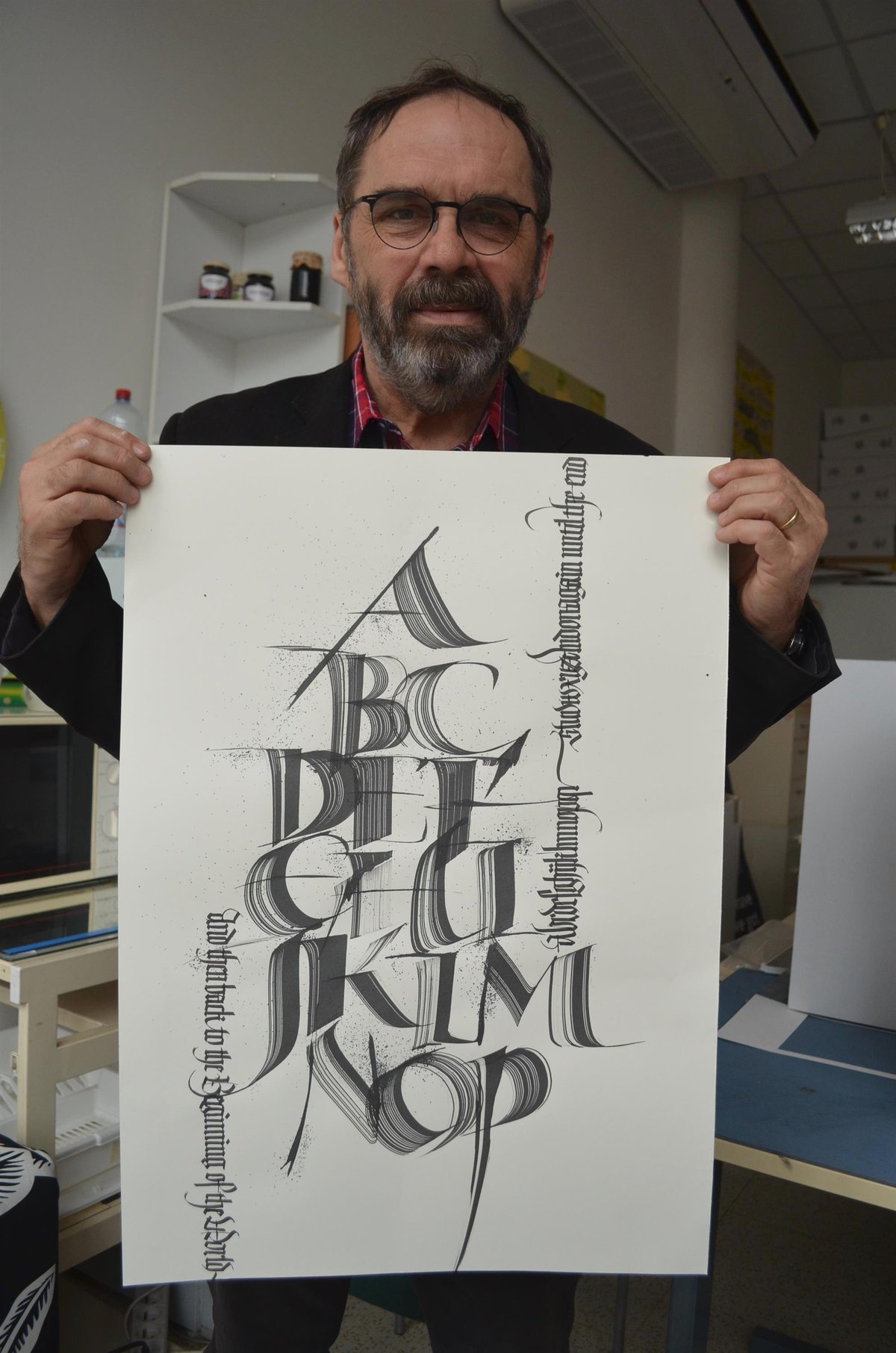 Vedoucí ateliéru Grafický design Rostislav Ilík ukazuje další ukázku vzácného hosta. Jedna z dalších ukázek profesora, který získal za svoji práci mnoho ocenění