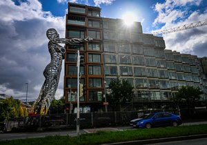 The twenty-four-meter colossus Lilith holds an apartment building in Prague's Karlín in her arms