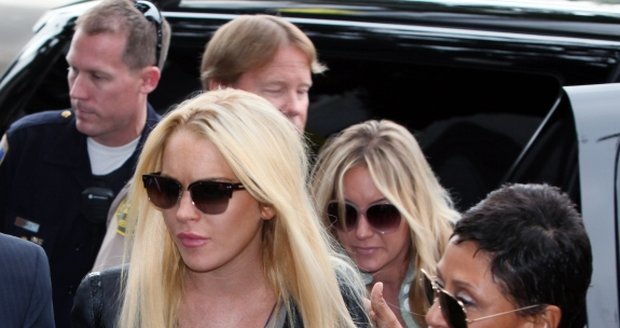 Lindsay Lohan se svou právničkou se prodírá davem fotografů a fanoušků směrem k věznici.