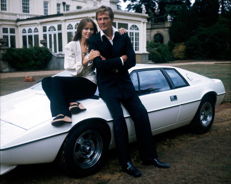 Agent 007 Roger Moore a Barbara Bach pózují před bílým Lotusem Esprit S1.