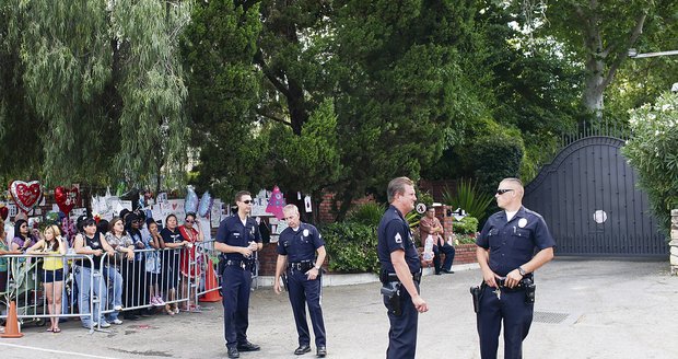 V místě neustále hlídkuje policie, fanoušci přinášejí květiny i dárky na počest zesnulého zpěváka   