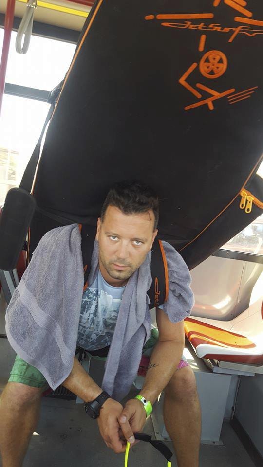 Michal vozí surf v autobusu na zádech.