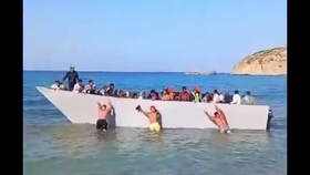 Turisté odtlačili loď s migranty zpět na moře