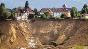 Na tomto místě vyhasly tři lidské životy. Dva miliony kubíků země je pochovaly. Dva domy a vyhlídková terasa zmizely po stopadesátimetrovém skluzu hluboko pod vodou a troskami.