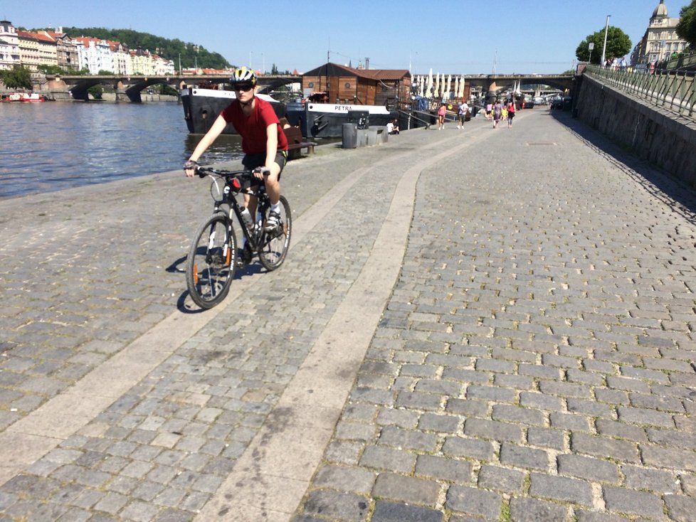 Cyklisté se po náplavce na Rašínově nábřeží pohybují v pěší zóně, cyklostezka tudy nevede.